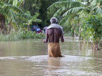 An elderly man walks through knee-deep flood water in the Aburhat area of Mirsarai Upazila in Chittagong Division, Bangladesh, on August 26,...