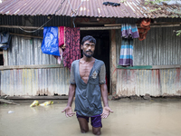 A man stands crying in front of his flooded house in the Aburhat area of Mirsarai Upazila in Chittagong Division, Bangladesh, on August 26,...