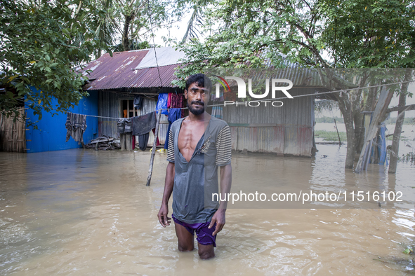 A man stands crying in front of his flooded house in the Aburhat area of Mirsarai Upazila in Chittagong Division, Bangladesh, on August 26,...