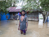 A man stands crying in front of his flooded house in the Aburhat area of Mirsarai Upazila in Chittagong Division, Bangladesh, on August 26,...