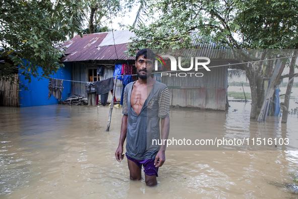 A man stands crying in front of his flooded house in the Aburhat area of Mirsarai Upazila in Chittagong Division, Bangladesh, on August 26,...