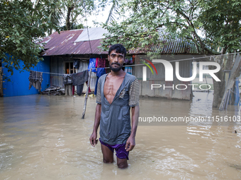 A man stands crying in front of his flooded house in the Aburhat area of Mirsarai Upazila in Chittagong Division, Bangladesh, on August 26,...