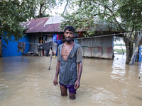 A man stands crying in front of his flooded house in the Aburhat area of Mirsarai Upazila in Chittagong Division, Bangladesh, on August 26,...