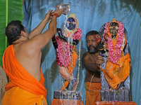 A priest performs 'Panchamrit Abhishek' at Radha Damodar Ji temple on the occasion of the Krishna Janmashtami festival in Jaipur, Rajasthan,...