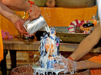 A priest performs 'Panchamrit Abhishek' at Radha Damodar Ji temple on the occasion of the Krishna Janmashtami festival in Jaipur, Rajasthan,...