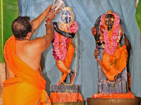 A priest performs 'Panchamrit Abhishek' at Radha Damodar Ji temple on the occasion of the Krishna Janmashtami festival in Jaipur, Rajasthan,...