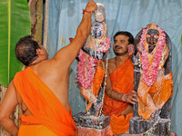 A priest performs 'Panchamrit Abhishek' at Radha Damodar Ji temple on the occasion of the Krishna Janmashtami festival in Jaipur, Rajasthan,...