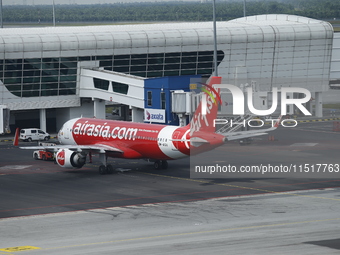 Air Asia low-cost commercial planes dock at Kuala Lumpur International Airport Terminal in Kuala Lumpur, Malaysia, on June 8, 2019. (