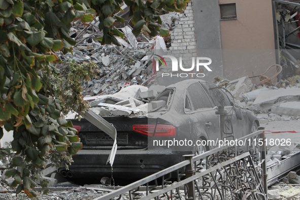 A crushed car is near a hotel destroyed by the Russian ballistic missile attack late on Monday, August 26, that claims the lives of two peop...