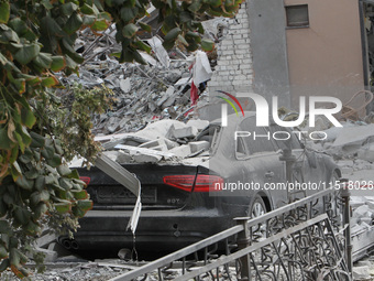 A crushed car is near a hotel destroyed by the Russian ballistic missile attack late on Monday, August 26, that claims the lives of two peop...