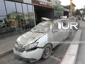 A crushed car is near a hotel destroyed by the Russian ballistic missile attack late on Monday, August 26, that claims the lives of two peop...