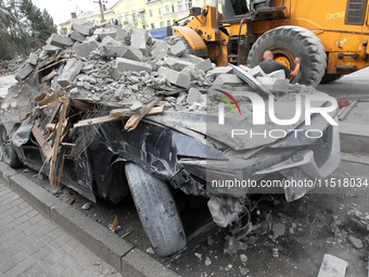 A crushed car is near a hotel destroyed by the Russian ballistic missile attack late on Monday, August 26, that claims the lives of two peop...