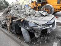 A crushed car is near a hotel destroyed by the Russian ballistic missile attack late on Monday, August 26, that claims the lives of two peop...