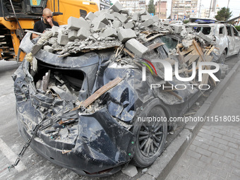 A crushed car is near a hotel destroyed by the Russian ballistic missile attack late on Monday, August 26, that claims the lives of two peop...