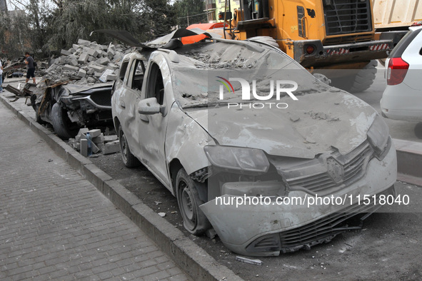 A crushed car is near a hotel destroyed by the Russian ballistic missile attack late on Monday, August 26, that claims the lives of two peop...