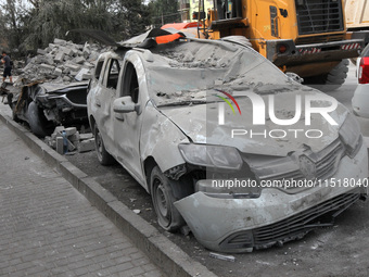 A crushed car is near a hotel destroyed by the Russian ballistic missile attack late on Monday, August 26, that claims the lives of two peop...