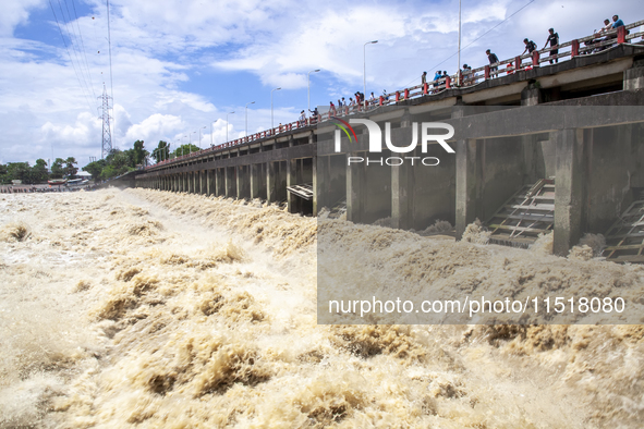 Heavy flow of flood water is seen in the Muhuri irrigation project of Sonagazi upazila in Feni district in Chittagong, Bangladesh, on August...