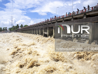 Heavy flow of flood water is seen in the Muhuri irrigation project of Sonagazi upazila in Feni district in Chittagong, Bangladesh, on August...