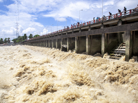 Heavy flow of flood water is seen in the Muhuri irrigation project of Sonagazi upazila in Feni district in Chittagong, Bangladesh, on August...