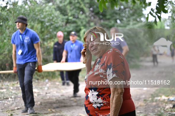 An elderly woman wipes away tears during a response effort to a Russian Shahed drone collapse in a residential area in Zaporizhzhia, Ukraine...