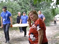 An elderly woman wipes away tears during a response effort to a Russian Shahed drone collapse in a residential area in Zaporizhzhia, Ukraine...