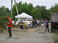 Locals accept aid after a Russian Shahed drone falls onto a residential area in Zaporizhzhia, Ukraine, on August 27, 2024. NO USE RUSSIA. NO...