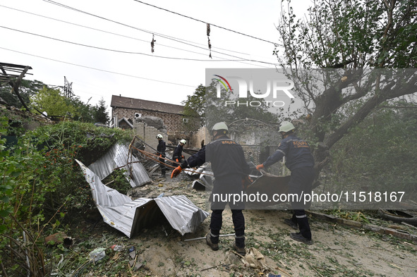 Workers of the Kobra emergency and rescue service remove the rubble at a house destroyed after a Russian Shahed drone falls onto a residenti...