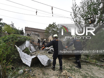 Workers of the Kobra emergency and rescue service remove the rubble at a house destroyed after a Russian Shahed drone falls onto a residenti...