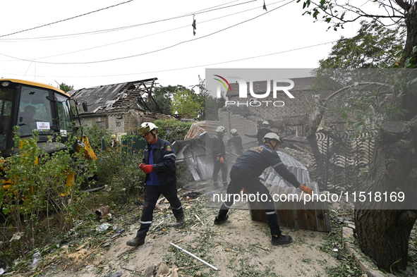 Workers of the Kobra emergency and rescue service remove the rubble at a house destroyed after a Russian Shahed drone falls onto a residenti...