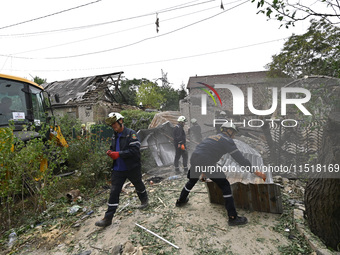 Workers of the Kobra emergency and rescue service remove the rubble at a house destroyed after a Russian Shahed drone falls onto a residenti...