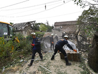 Workers of the Kobra emergency and rescue service remove the rubble at a house destroyed after a Russian Shahed drone falls onto a residenti...