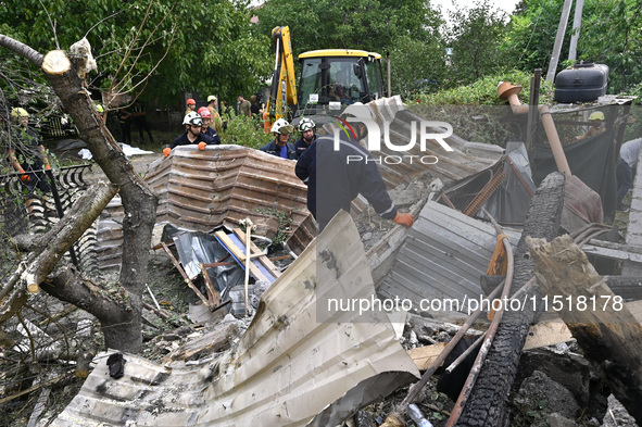 Workers of the Kobra emergency and rescue service remove the rubble at a house destroyed after a Russian Shahed drone falls onto a residenti...