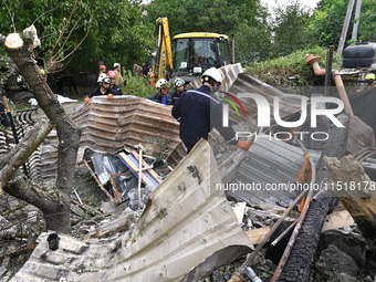 Workers of the Kobra emergency and rescue service remove the rubble at a house destroyed after a Russian Shahed drone falls onto a residenti...