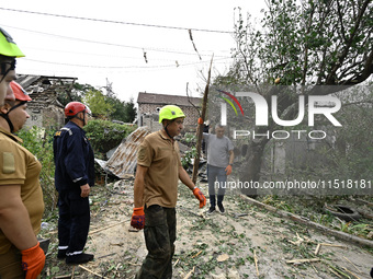 Workers of the Kobra emergency and rescue service remove the rubble at a house destroyed after a Russian Shahed drone falls onto a residenti...