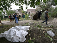 The bodies of victims in human remains pouches are on the ground during a response effort to a Russian Shahed drone collapse in a residentia...