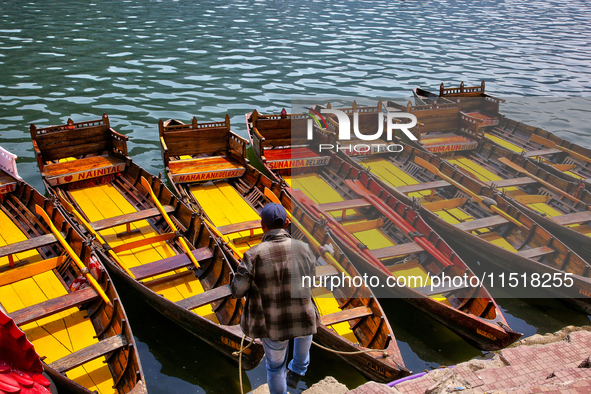 A boatman ties his boat along Naini Lake in Nainital, Uttarakhand, India, on April 21, 2024. 