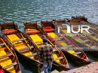 A boatman ties his boat along Naini Lake in Nainital, Uttarakhand, India, on April 21, 2024. (