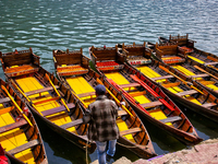 A boatman ties his boat along Naini Lake in Nainital, Uttarakhand, India, on April 21, 2024. (