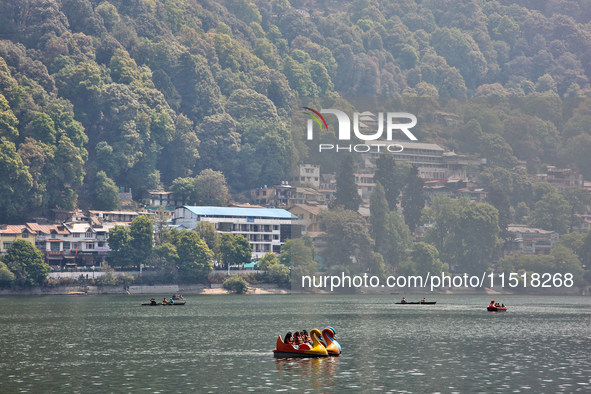 Indian tourists paddle boat along Naini Lake in Nainital, Uttarakhand, India, on April 21, 2024. 