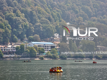 Indian tourists paddle boat along Naini Lake in Nainital, Uttarakhand, India, on April 21, 2024. (