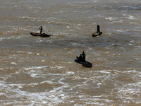 Villagers fish on their boat near the Chao Phraya Dam in Chai Nat province, north of Bangkok, on August 27, 2024. The dam releases water due...