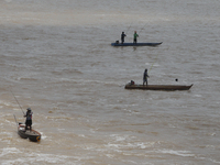 Villagers fish on their boat near the Chao Phraya Dam in Chai Nat province, north of Bangkok, on August 27, 2024. The dam releases water due...