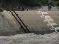 Villagers fish near the Chao Phraya Dam in Chai Nat province, north of Bangkok, on August 27, 2024. The dam releases water due to heavy floo...