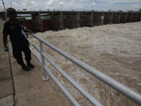 People watch as floodwaters are released from the Chao Phraya Dam in Chai Nat province, north of Bangkok, on August 27, 2024. The dam releas...