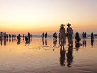 Tourists watch the sunrise at the Golden Beach in Qingdao, China, on August 28, 2024. (