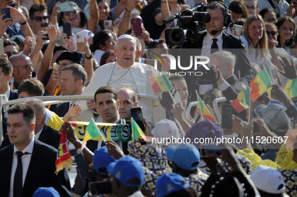 Pope Francis waves at the faithful during the weekly General Audience in Saint Peter's Square in Vatican City on August 28, 2024. 