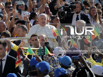 Pope Francis waves at the faithful during the weekly General Audience in Saint Peter's Square in Vatican City on August 28, 2024. (