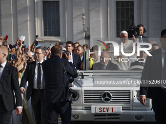 Pope Francis waves at the faithful during the weekly General Audience in Saint Peter's Square in Vatican City on August 28, 2024. (