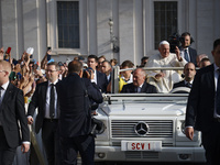 Pope Francis waves at the faithful during the weekly General Audience in Saint Peter's Square in Vatican City on August 28, 2024. (