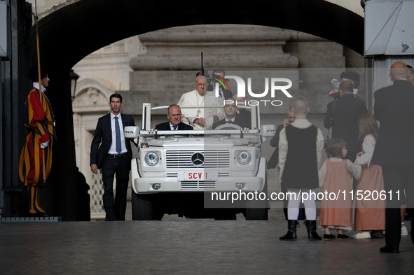 Pope Francis arrives in St. Peter's Square to lead the weekly General Audience in Vatican City on August 28, 2024. 